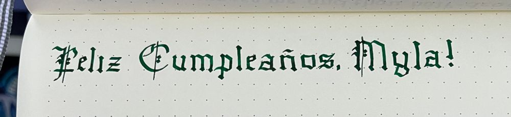 Photo of Gothic blackletter calligraphy reading Feliz Cumpleaños Myla!