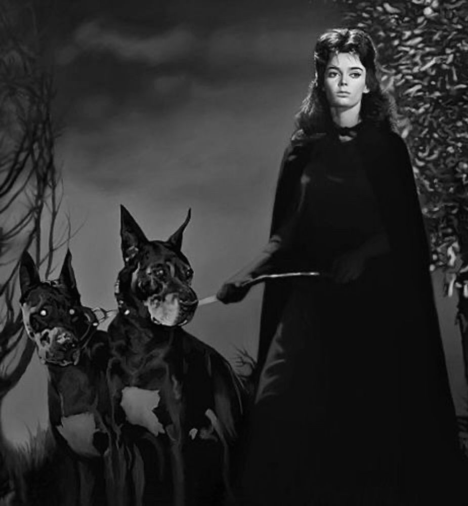 Barbara Steele as a witch holding onto a leash with two devil dogs in BLACK SUNDAY (1960).