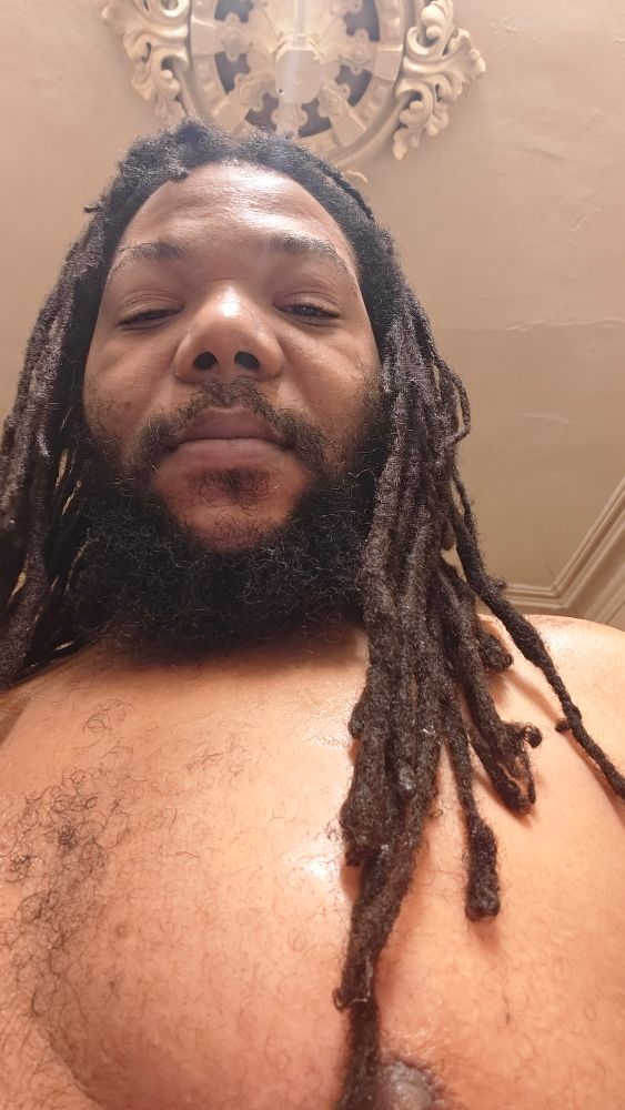 Pic of me after a quick hair wash. My longer locs stretch down to my chest now. 