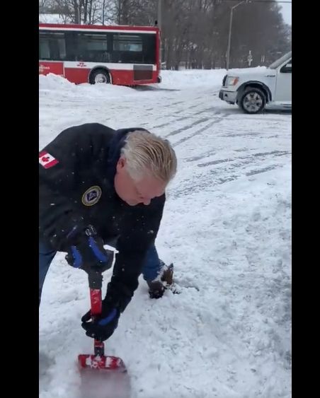 Ontario Premier Doug Ford helping dig Torontonians out of the snow with the world’s smallest shovel