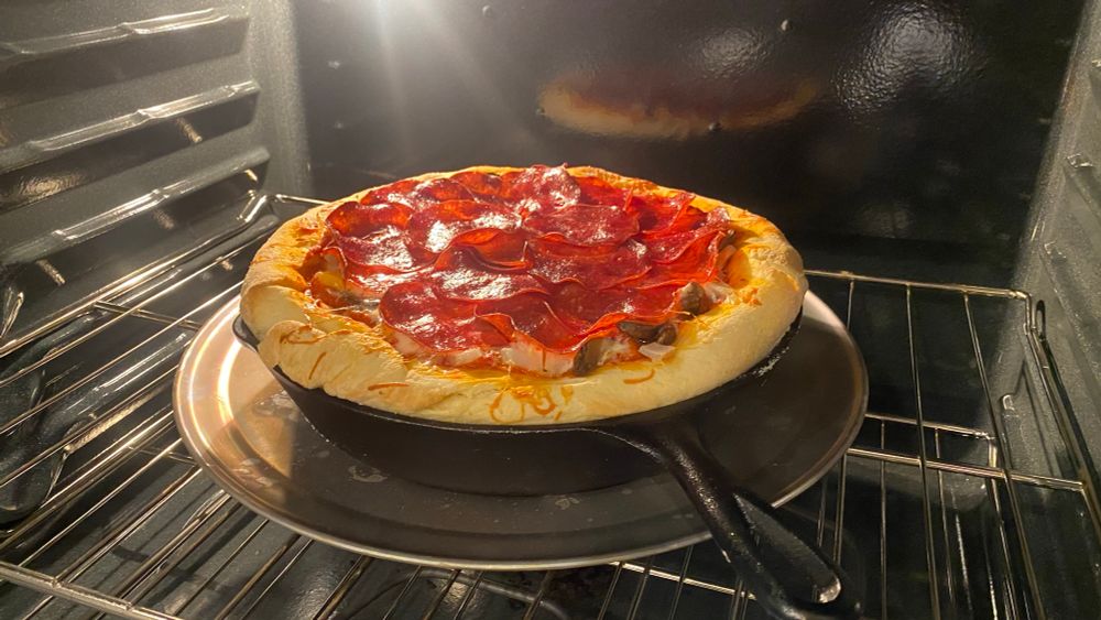 Finished deep dish pizza, baked in a cast iron pan