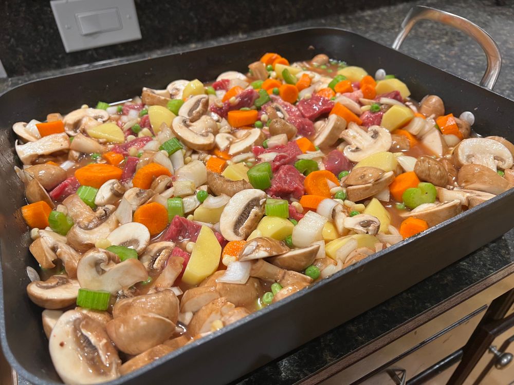 Stew assembled in roasting pan before cooking