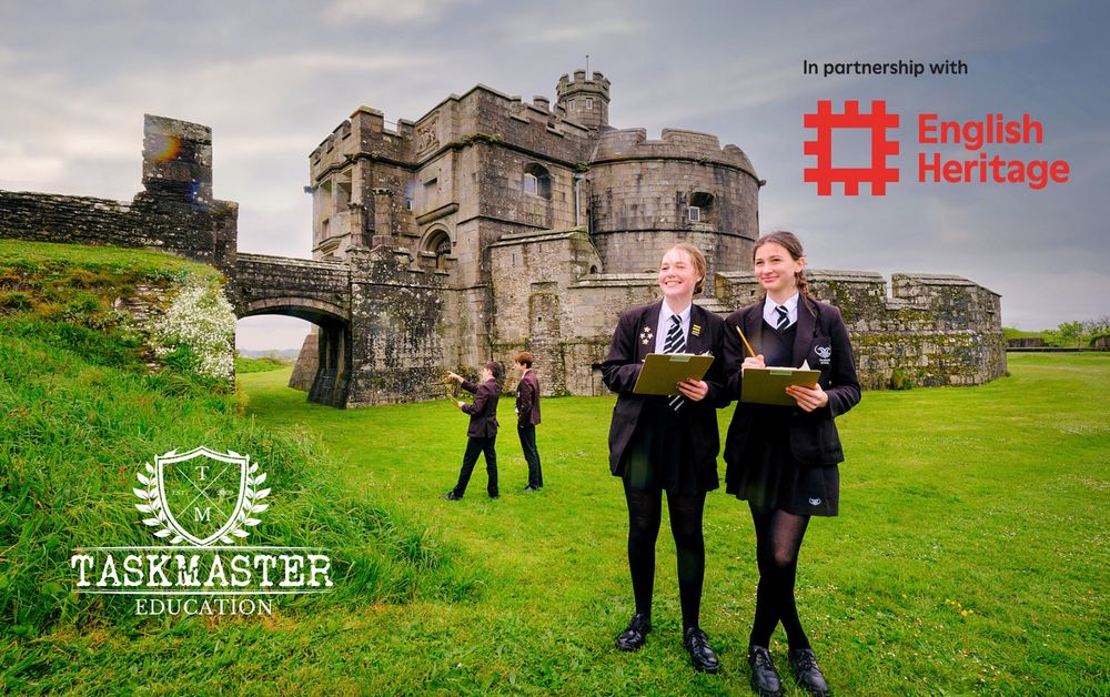 Two female secondary school pupils stand on grass outside a castle. They hold clipboards. The English Heritage logo is top right and Taskmaster Education logo bottom left of the image.