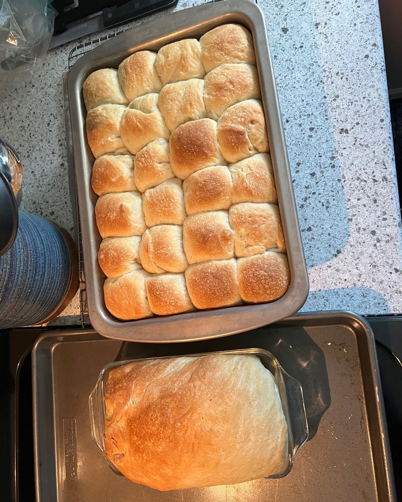 Homemade sourdough bread - a loaf and a pan of rolls - fresh from the oven