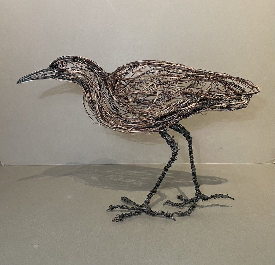 Bitern, a heron shaped bird, made of wrapped and twisted silver, copper, and gunmetal wire.