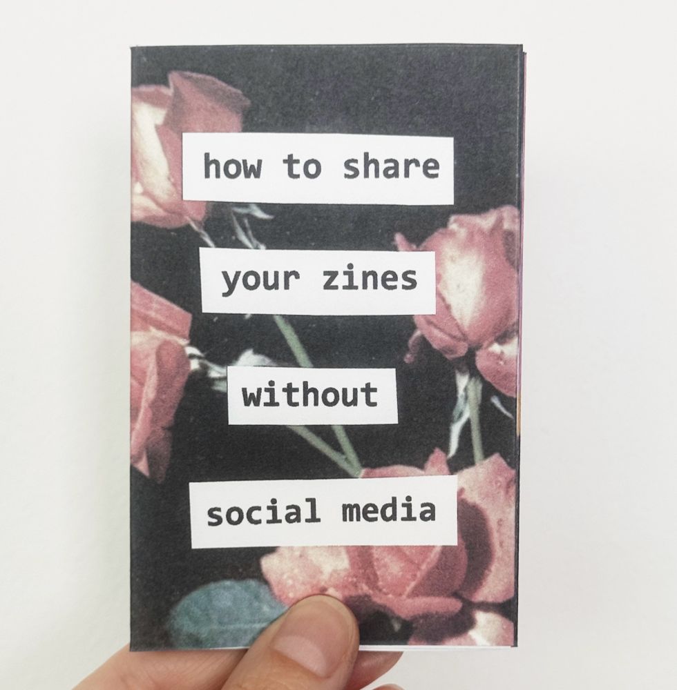 a hand holding up a zine. “how to share your zines without social media”