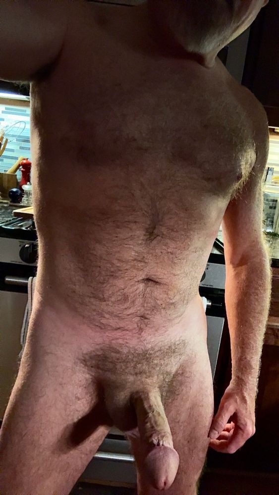 Furry naked Dad standing in the kitchen with a hard fat cock. 