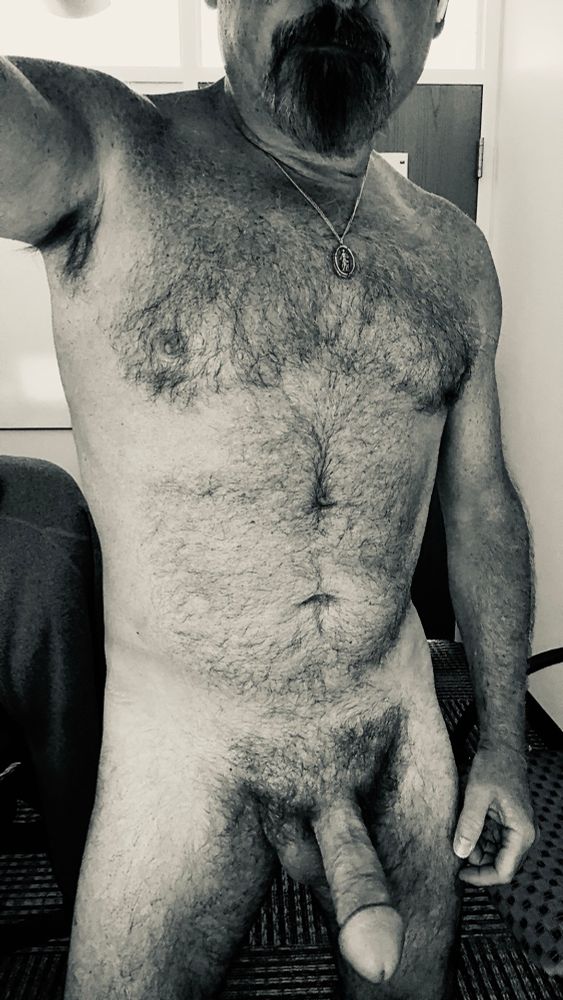 Black and white image of a furry guy with a fat hard cock. 