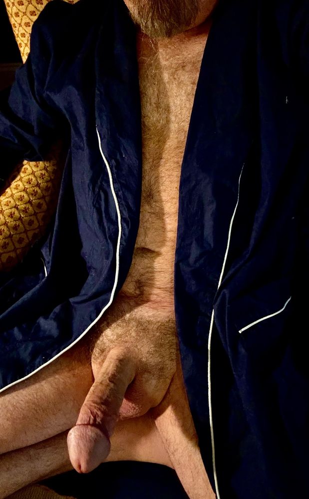 Furry naked Dad wearing only a dark
Blue robe with white trim, sitting in a chair with his hard thick cock sticking out of the open robe. 