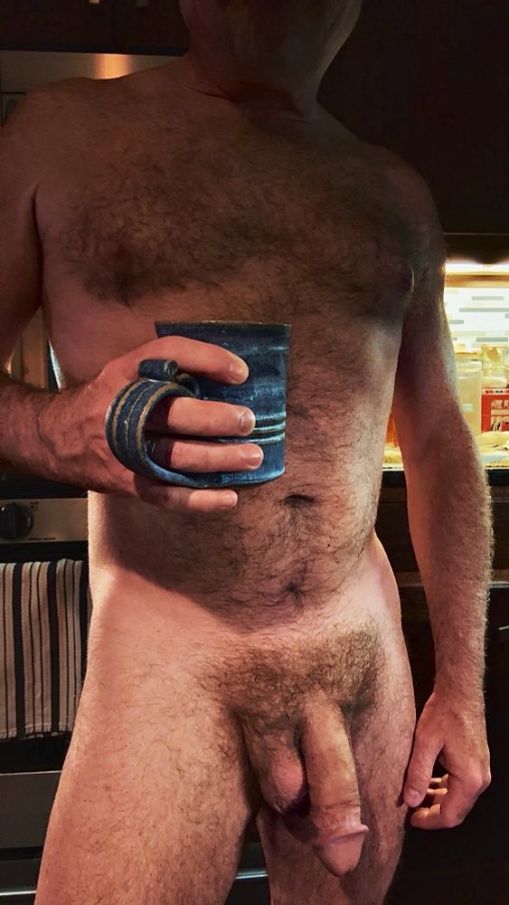 Furry naked Dad standing in the kitchen, coffee mug in hand, soft fat cock between his legs. 