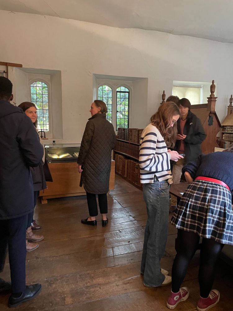Several people are looking at items in the Old library