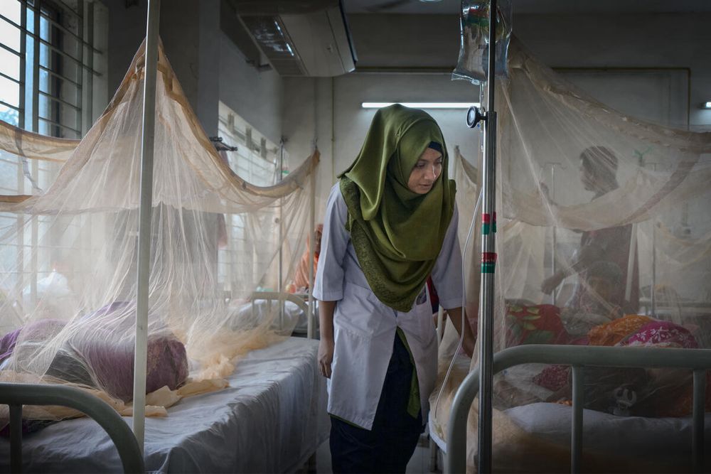 Tania attends to a patient in the dengue ward at Mugda Hospital in Dhaka, Bangladesh, on 20 September 2023.