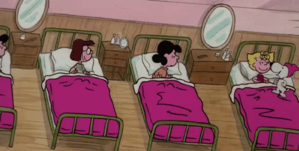 a group of cartoon characters are laying in beds with pink blankets