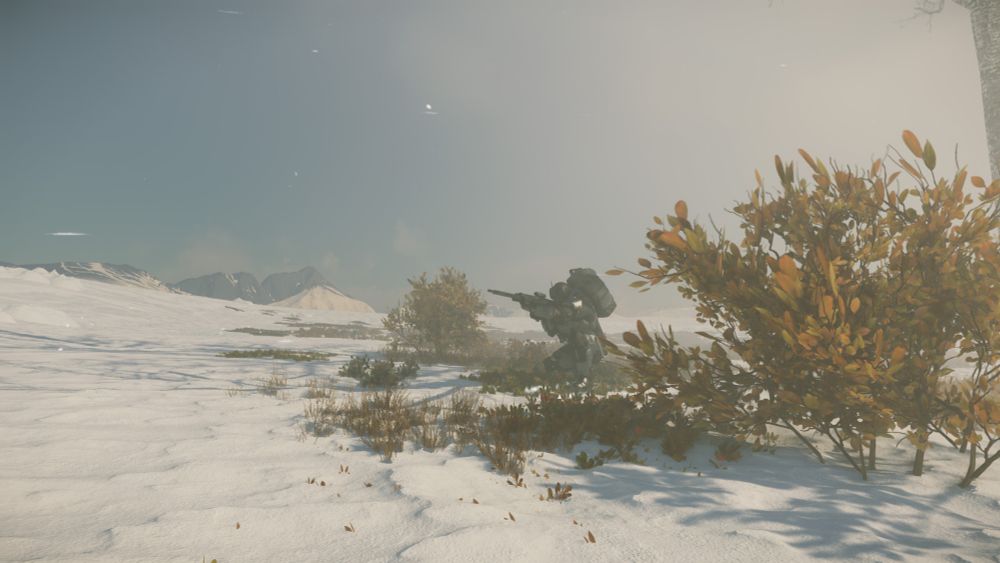 Armored figure with a sniper rifle in bushes on a snowy landscape 