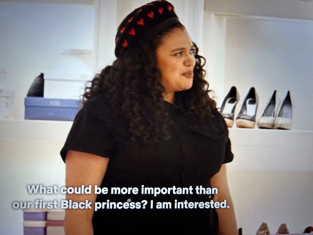 Fashionable Black woman in a huge walk-in closet asks: “What could be more important than our first Black Princess? I am interested.” 