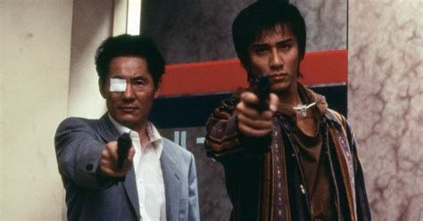 two Japanese hitmen aim guns at the camera in Takashi Ishii's Gonin