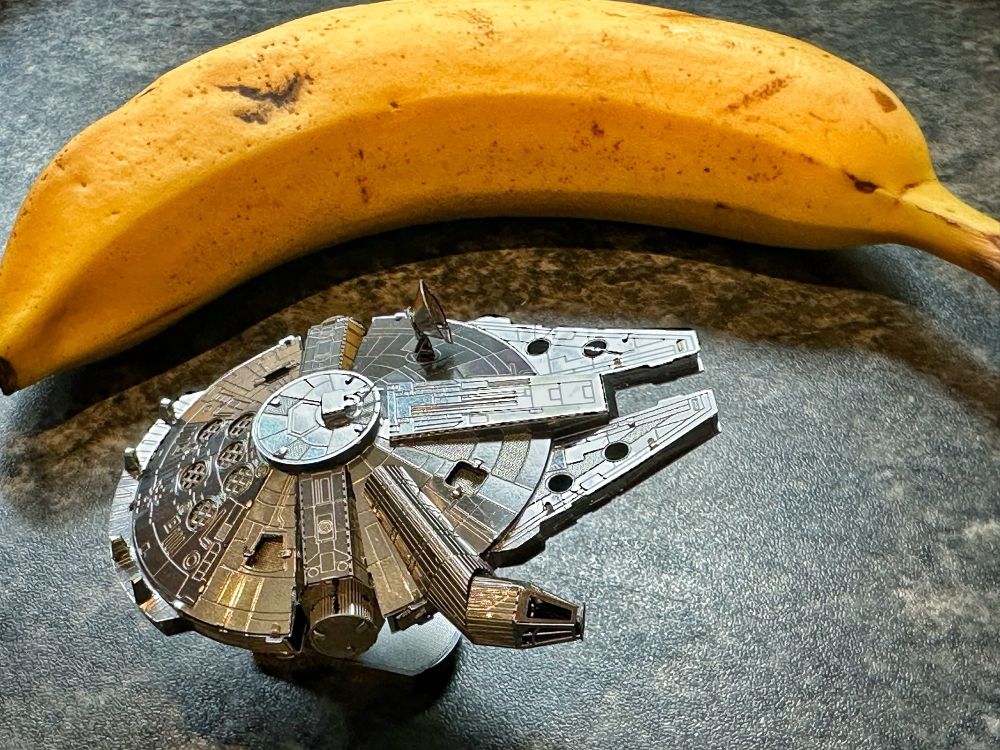 A small metal model of the Millennium Falcon. With a banana for scale. 