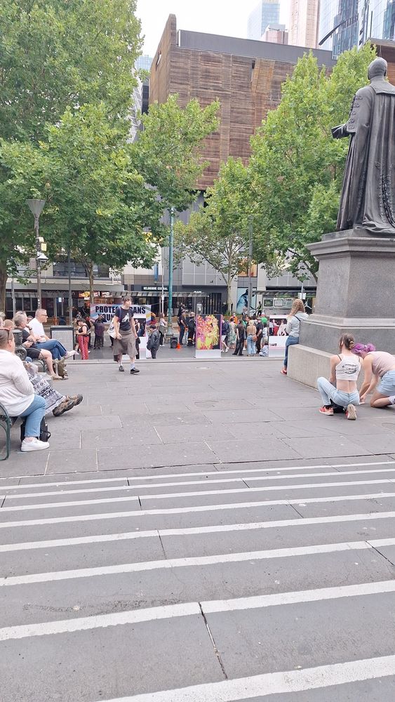 People gathering at a protect trans youth rally outside State Library.