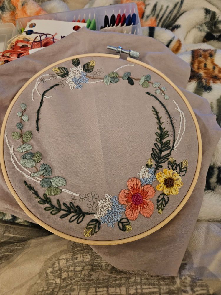 Progession photo of embroidery project with flowers 