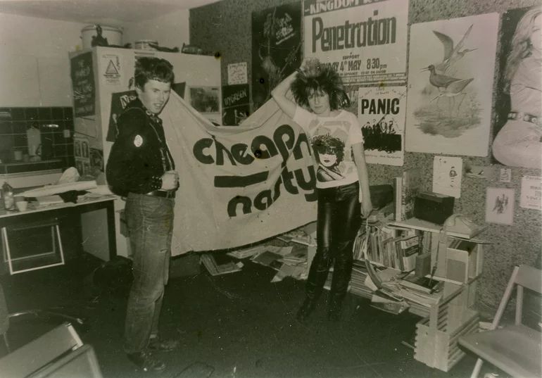 1981 photo by Annelies of Herman+Terry of Cheap 'n' Nasty for Vinyl zine with Siouxsie T-shirt+Penetration and Ivy Green posters