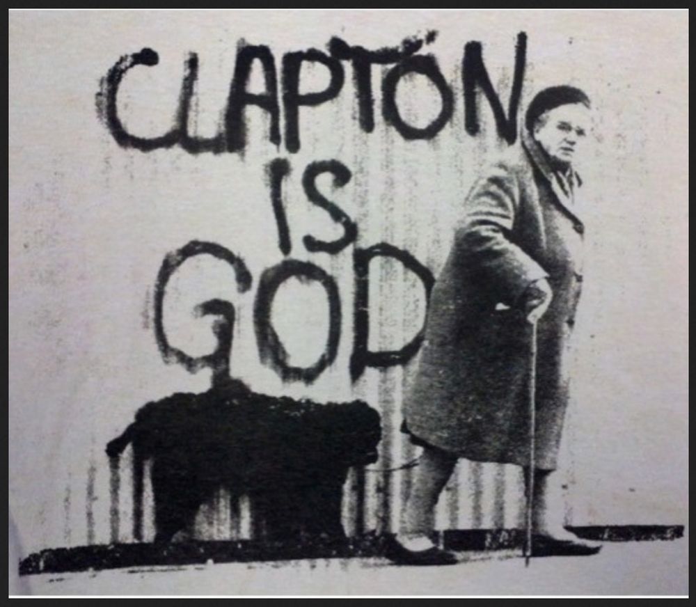 old photo of British woman with cane walking past "CLAPTON IS GOD" graffiti, possibly with a black dog?