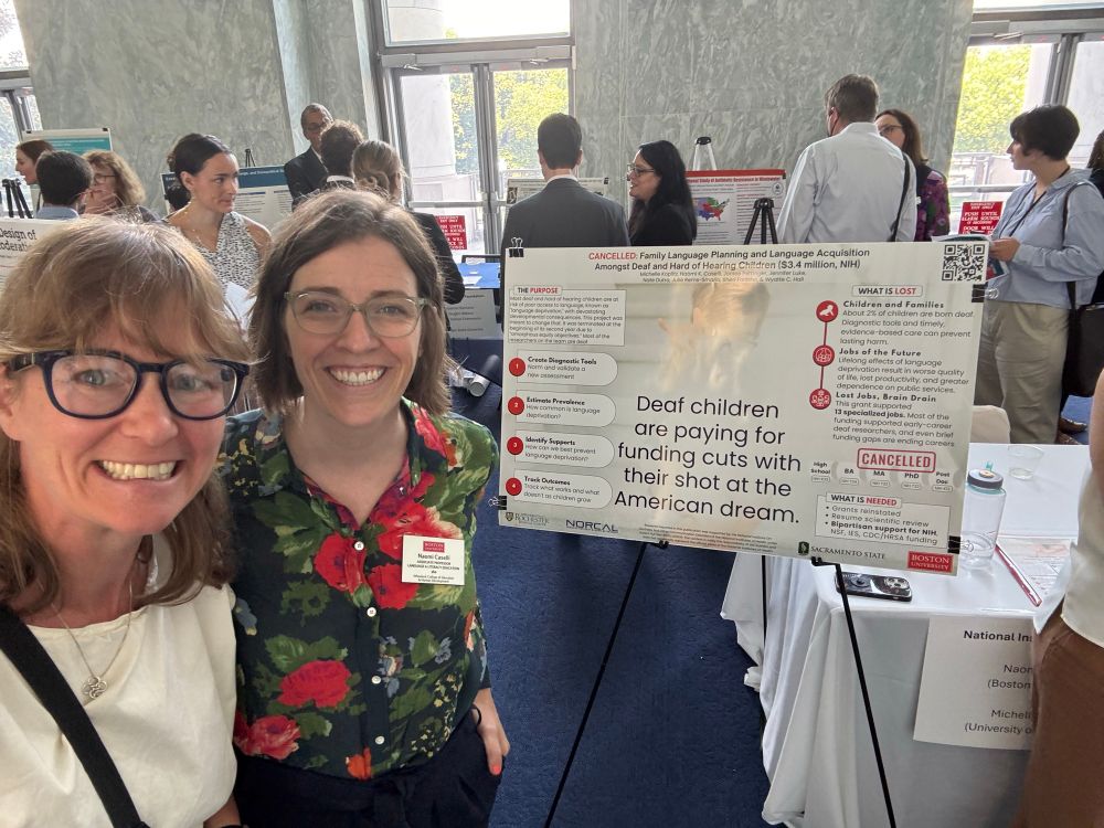 Jenna Norton and Naomi Caselli in front of Naomi’s poster at the science fair for canceled grants. 