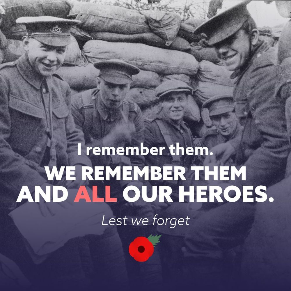 Old photograph of several military personnel in uniform sitting together behind sandbags, with the text 'I remember them. WE REMEMBER THEM AND ALL OUR HEROES. Lest we forget' and a poppy symbol for remembrance.