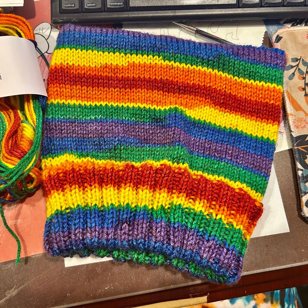 A knitted hat in rainbow with a squared top for a cat ear look