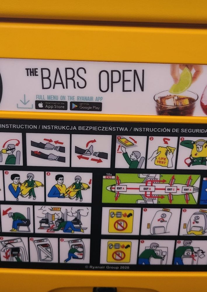 Advertisements on back of a seat on a Ryanair flight. It says The Bars Open with a no apostrophe 