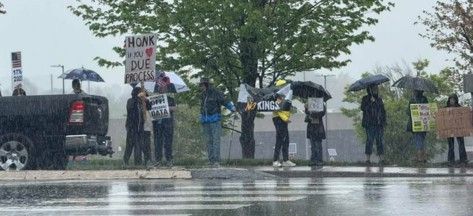 Very wet protesters at the No Kings Peaceful Protest, Springfield PA at the intersection of Baltimore Pike and 320, Saturday 4/26/25.