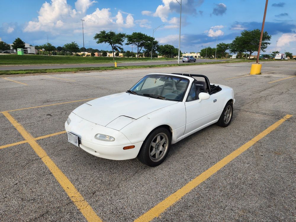 A 1990 Mazda Miata in a parking lot