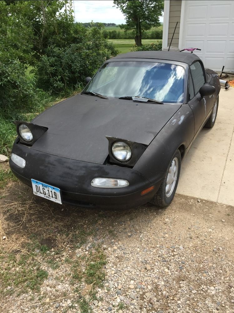 A 1990 Mazda Miata with unfinished paint