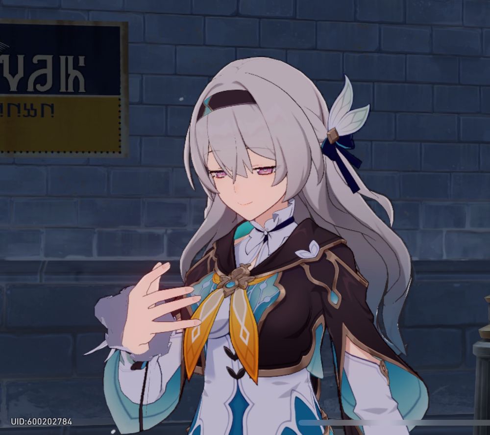 A screenshot of Firefly from Honkai: Star Rail staring at her empty hand as if holding an invisible phone. Her eyes are half closed in mid blink.
