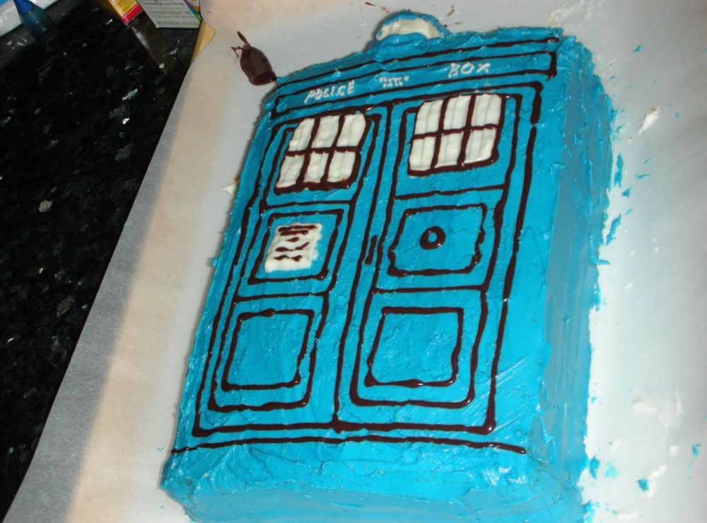 A birthday cake cut and frosted to look like the TARDIS from Doctor Who