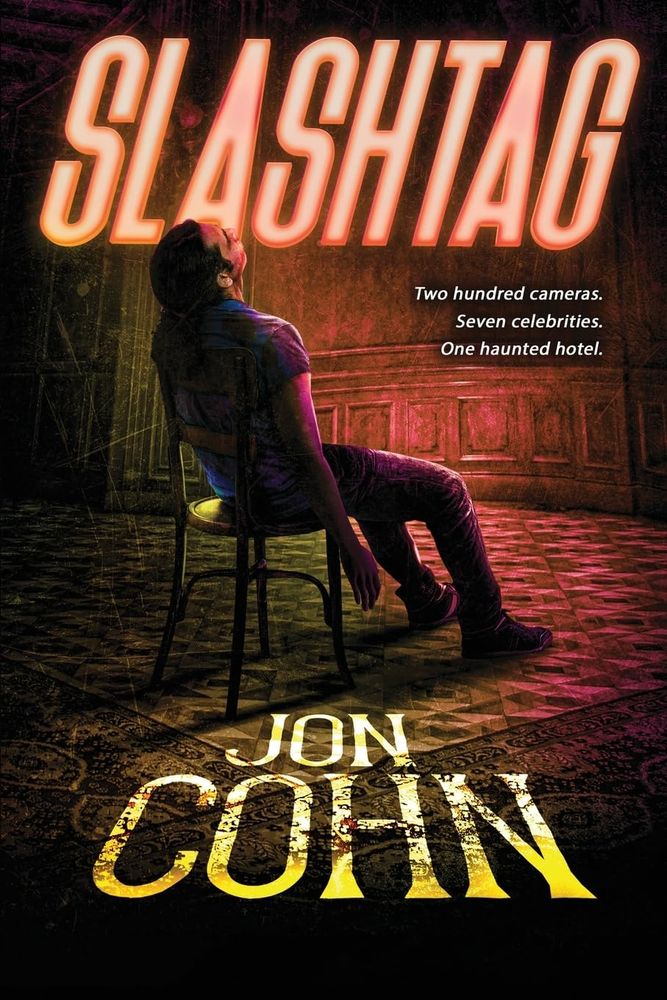 Cover of book "SLASHTAG" by John Cohn. The tag line reads, "Two hundred cameras. Seven celebrities. One haunted hotel." and it shows a person sitting in a chair seemingly out of it. Spooooky!