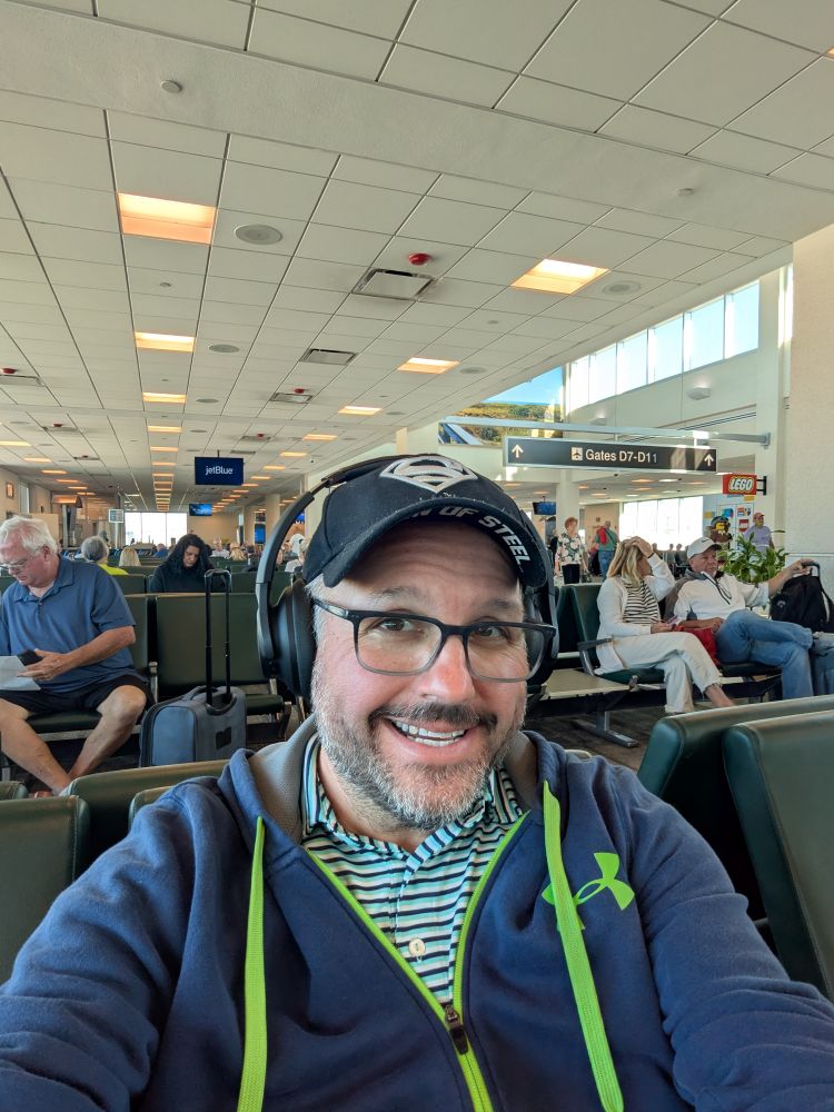 Man smiling at Fort Myers airport because he's going home.