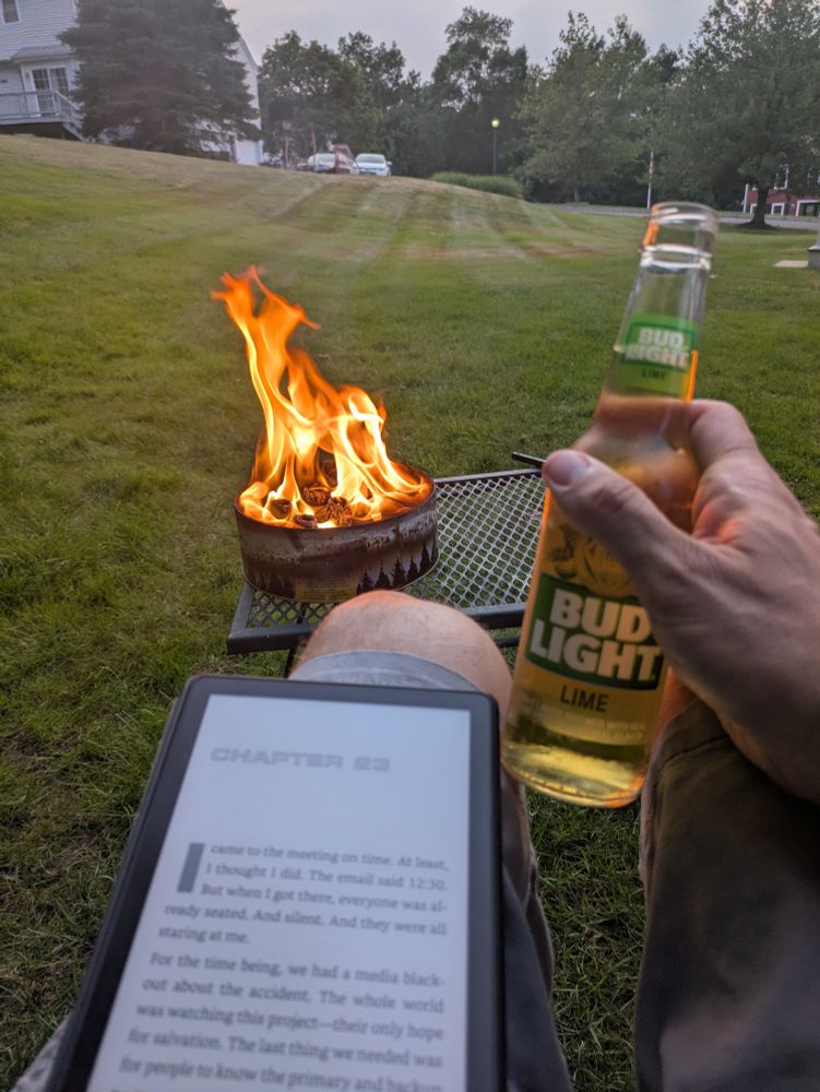 My hand holding a Bud light lime. My Kindle ready to be read. And a campfire in a can I first saw on Shark tank.