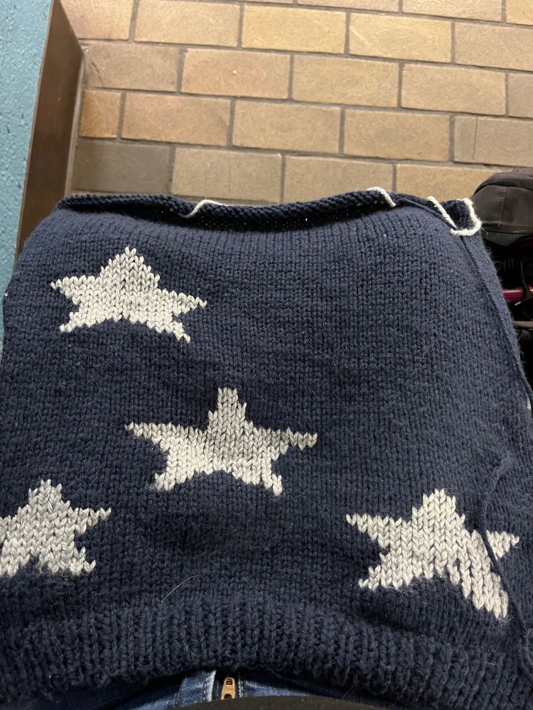 Navy blue knitted panel with four stitched on silver stars