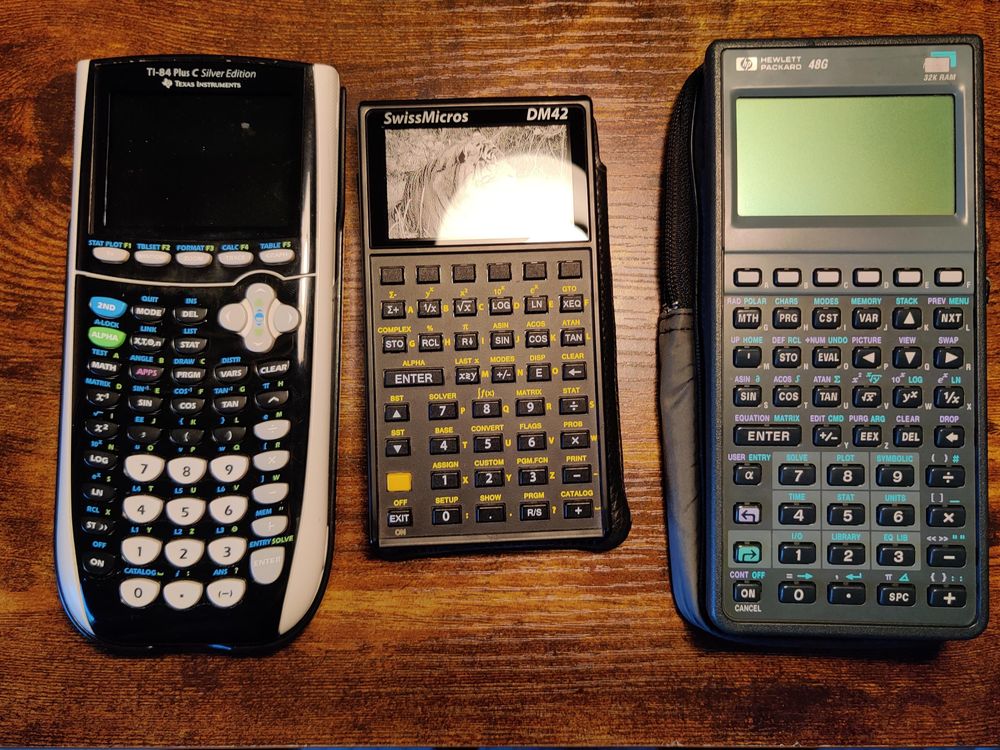 A TI-84+ CSE, SwissMicros DM42, and HP-48G