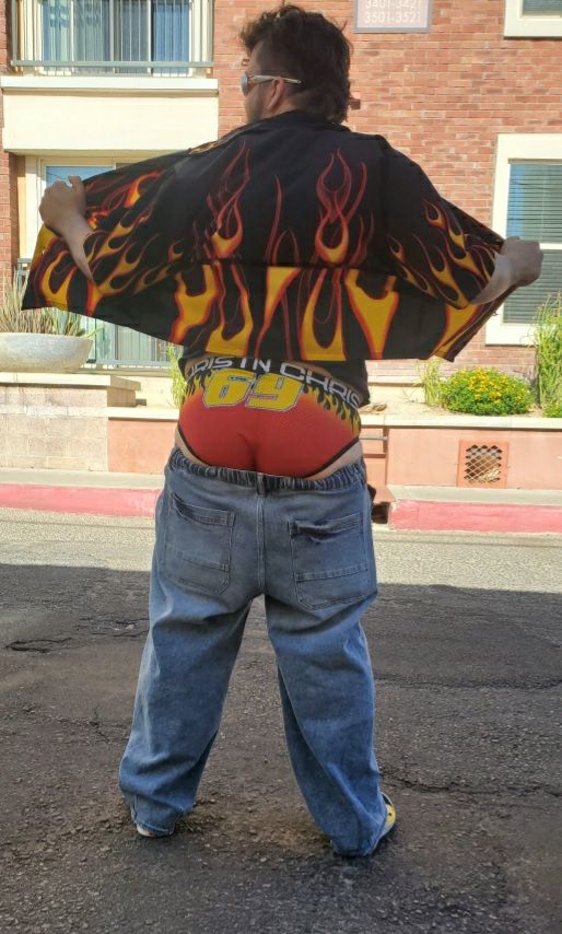 Picture of me with my back to the camera in a black, flame-pattern button shirt wearing sunglasses with flames on the sides. My blue jeans are lowered to reveal my butt wearing red briefs with a flame pattern and "69" in big, bold yellow letters in the middle of the seat