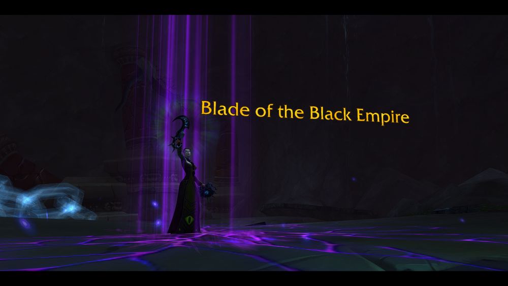 Blood elf shadow priest holding the Blade of the Black Empire aloft. 
