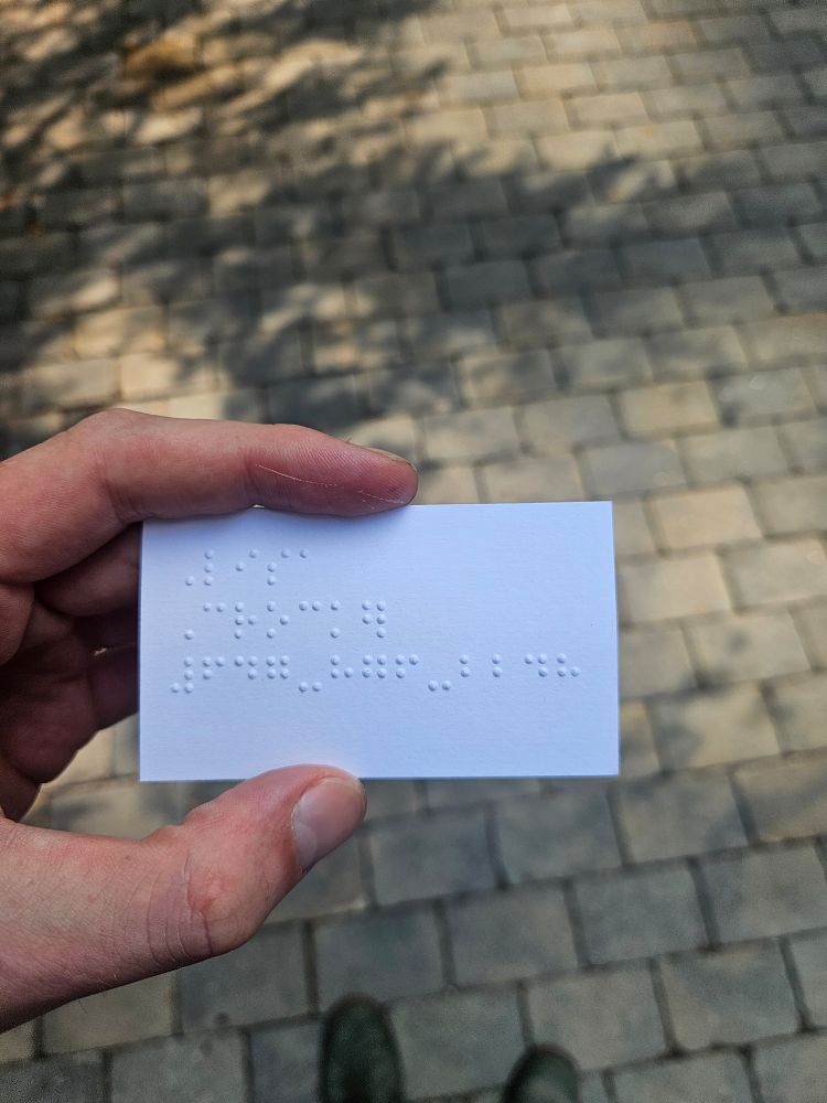 The reverse side of the cars shows several lines of braille text