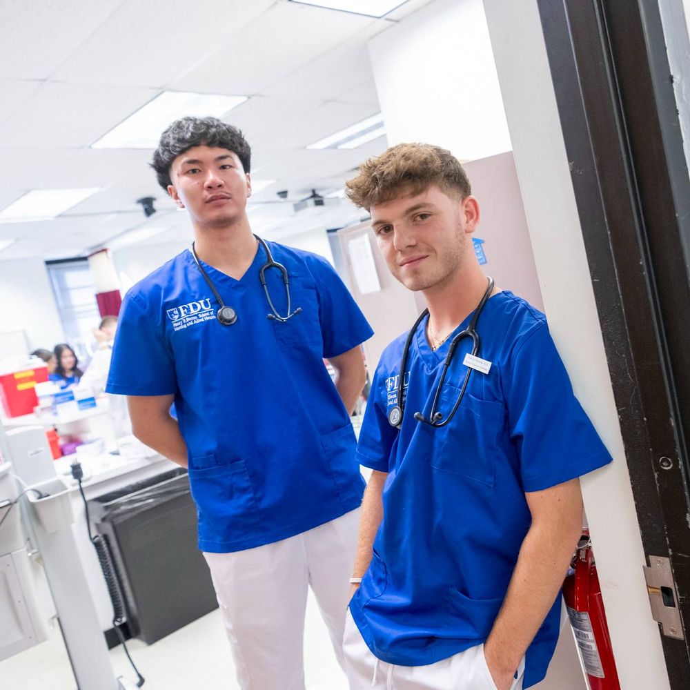 Two FDU Health students stand in the doorway to a classroom.