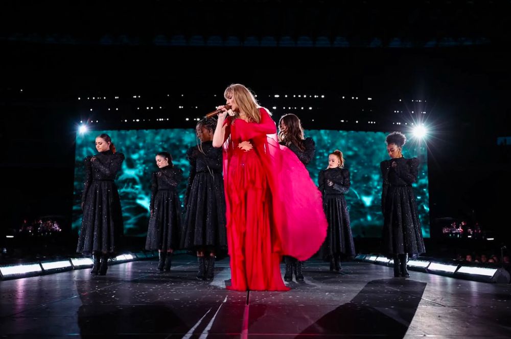 Taylor Swift performing “My Tears Ricochet” in her berry colored folkmore dress at The Eras Tour.