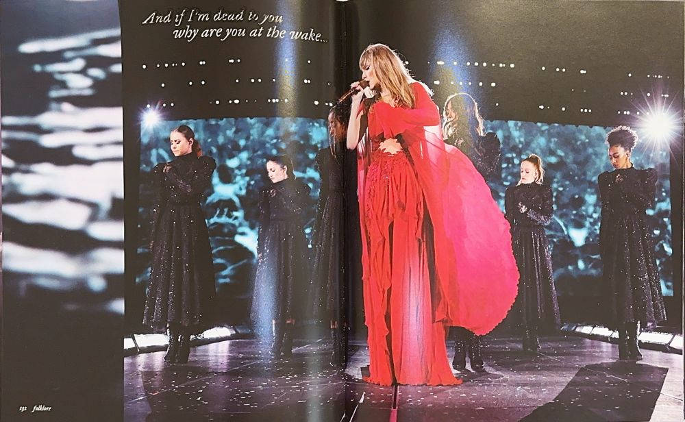 Taylor Swift performing “My Tears Ricochet” in her berry colored folkmore dress at The Eras Tour.