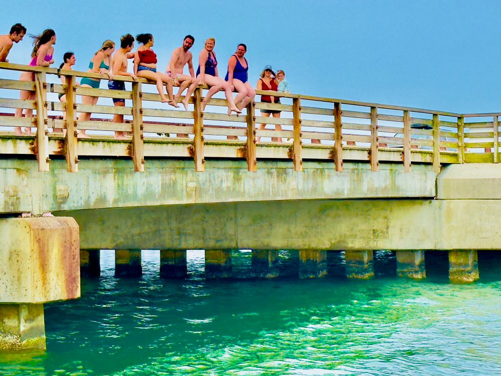 A group of people standing behind and on top of the Jaws Bridge. 