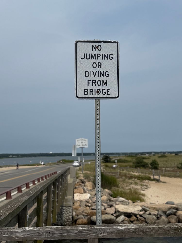 Sign on Jaws Bridge in Edgartown, MA, that says “NO JUMPING OR DIVING FROM BRIDGE”