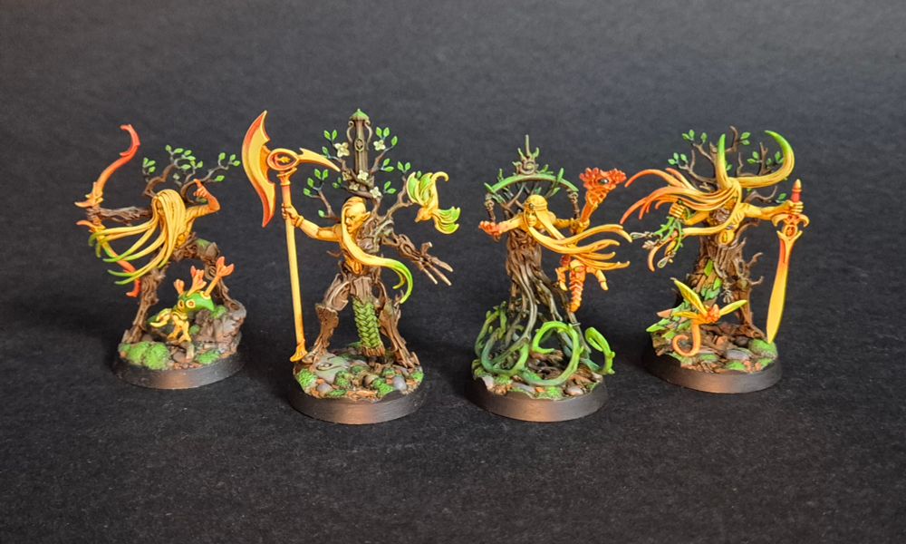 Ylthari's Guardians Warhammer Underworlds warband painted in yellow, orange, green and brown.