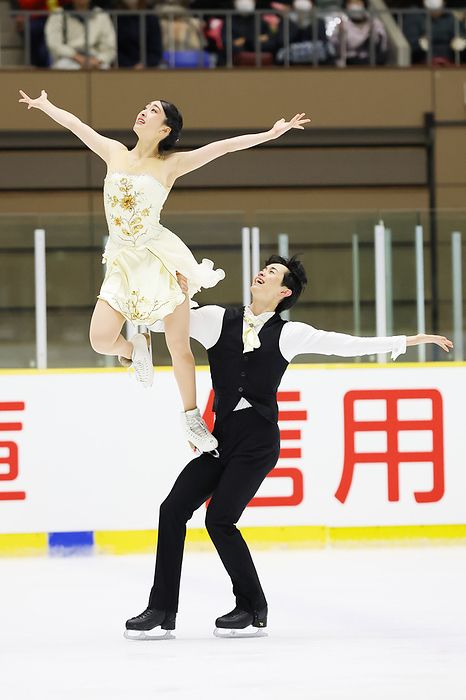 Ikura Kushida and Koshiro Shimada performing their FD. They are doing a lift in which Ikura is standing on one leg on Koshiro’s thigh, arms stretching to the sides
by AFLO