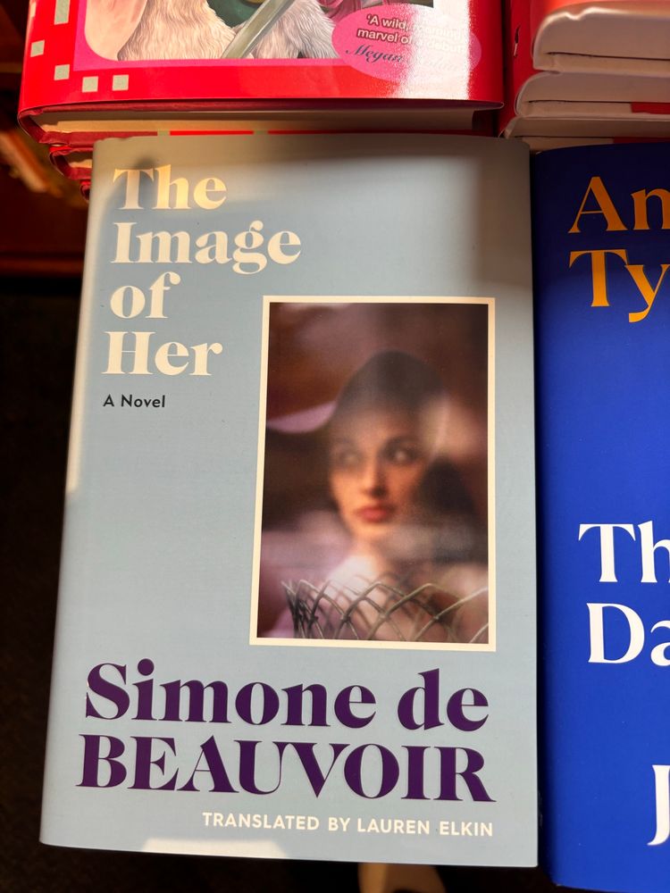 Photo of a book on the corner of a bookshop table: The Image of Her by Simone de Beauvoir, translated by Lauren Elkin 